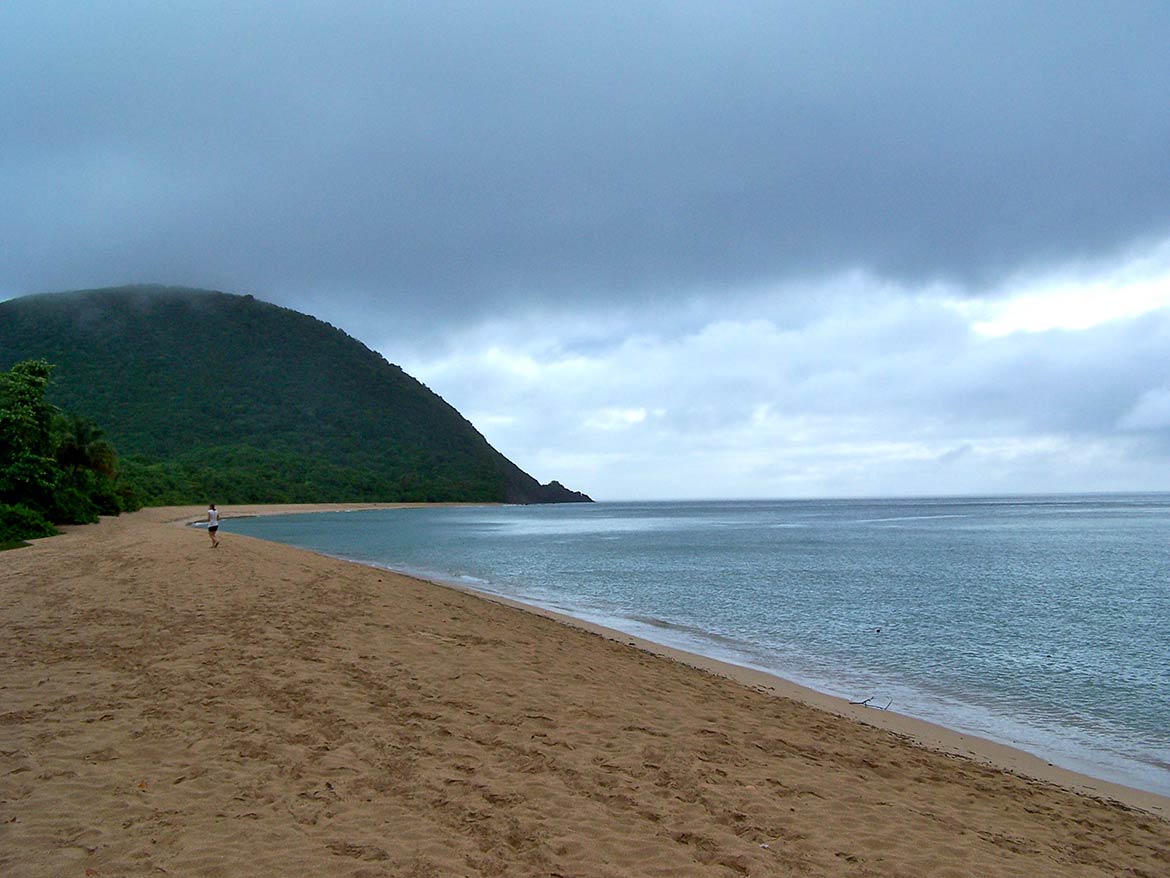 Beach of Grande Anse near Deshaies, with view of the tip of Gros Morne.