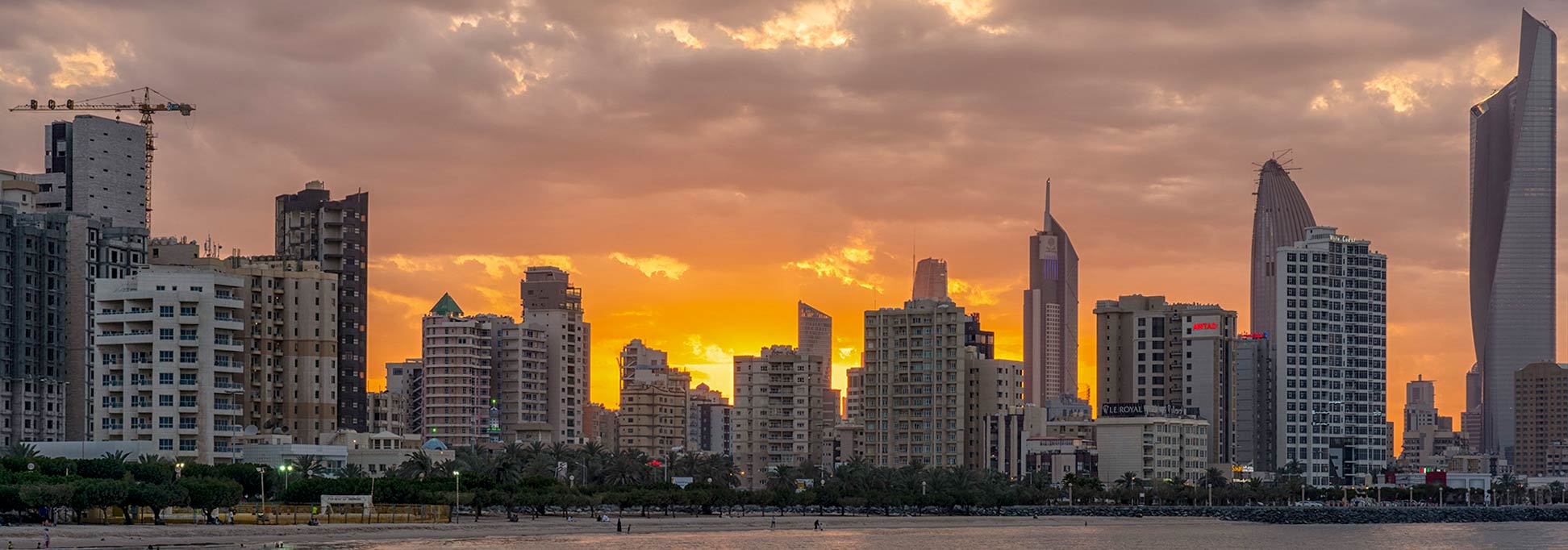 Skyline of Kuwait City at dawn.