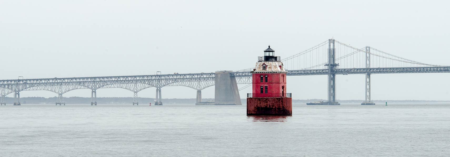 Chesapeake Bay Bridge over the Chesapeake Bay with Sandy Point Shoal Lighthouse